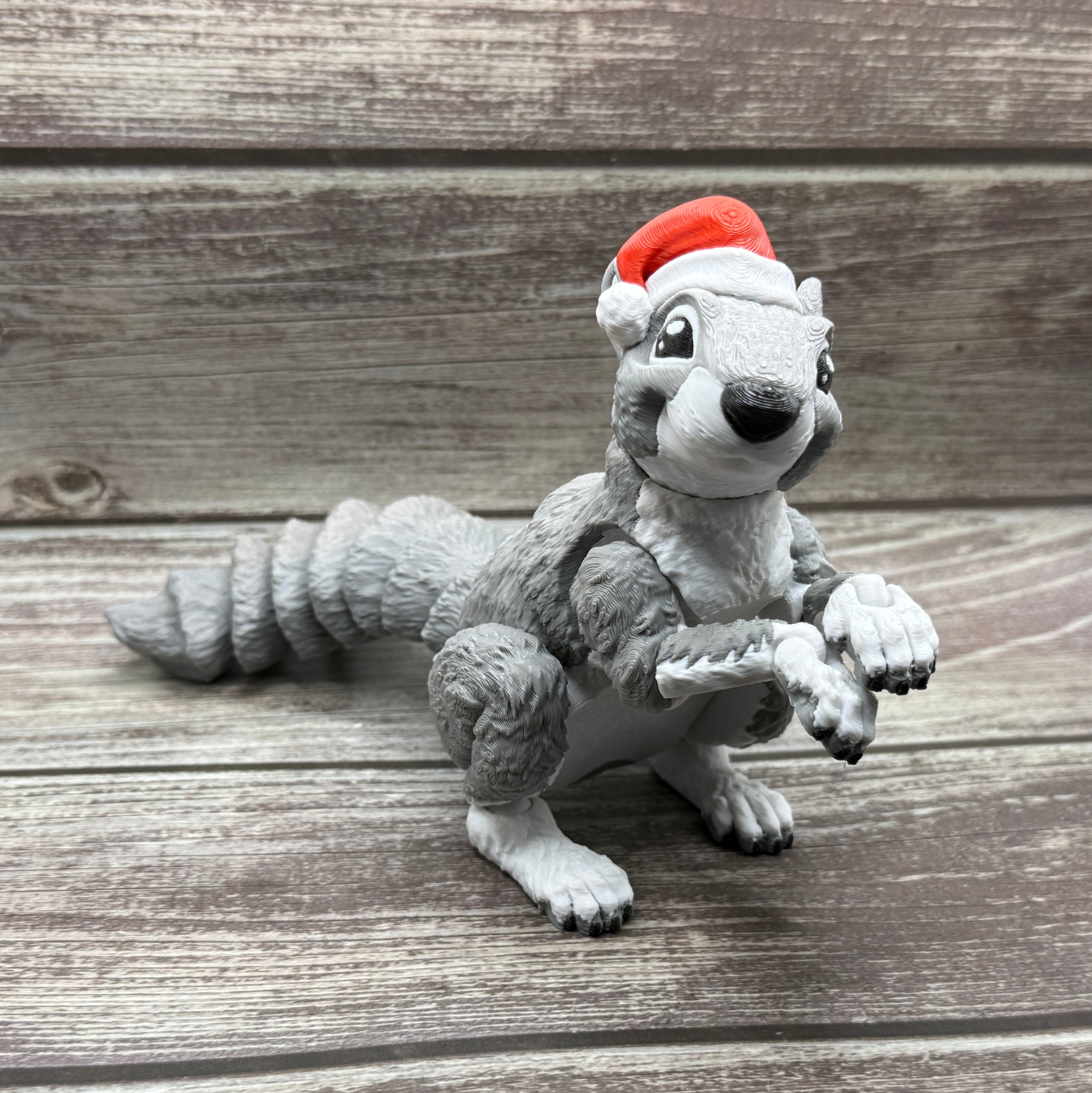 Gray squirrel figurine with Santa hat